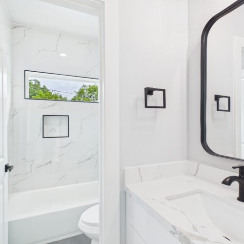 Guest bathroom with neutral tile and modern fixtures