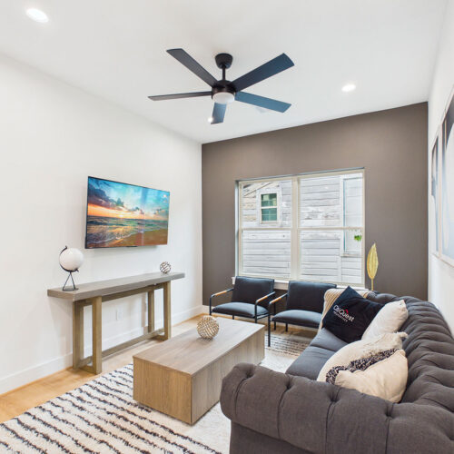 Flex room with modern furnishings, accent wall, and versatile living space in Houston new construction home.