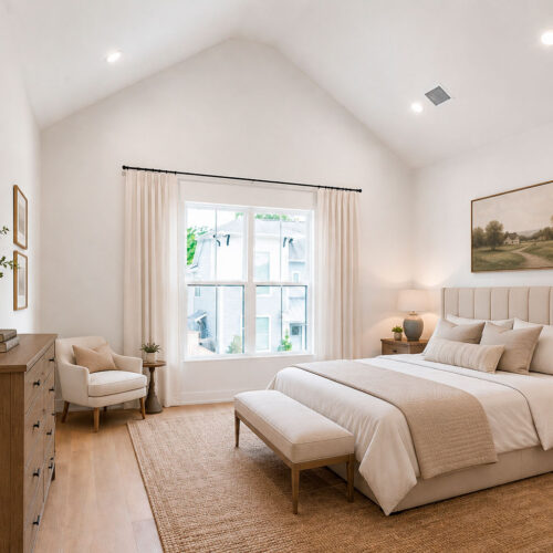 Luxury primary bedroom in The Heights Houston featuring vaulted ceilings, hardwood flooring, and abundant natural light.